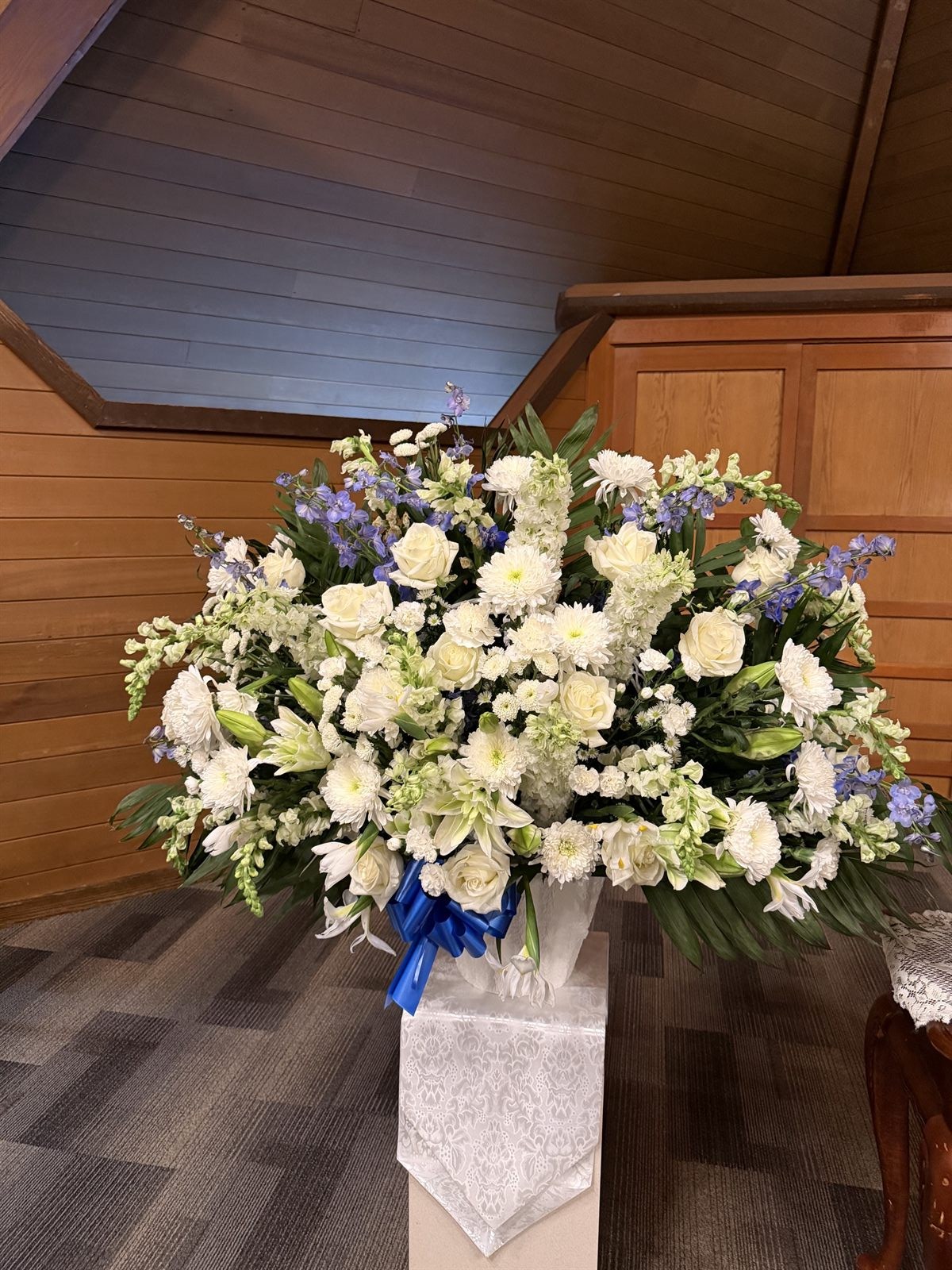 White and blue memorial arrangement